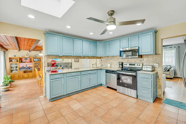 a kitchen with stainless steel appliances granite countertop a stove sink and cabinets