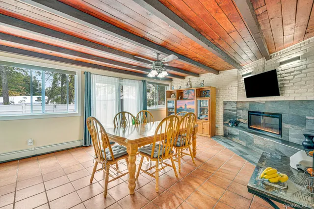 a dining room with furniture garden view and a fireplace