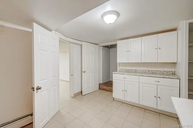 a spacious bathroom with a granite countertop sink and a vanity