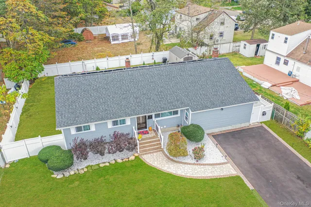 an aerial view of a house with yard