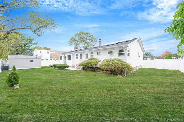 a view of a house with a backyard