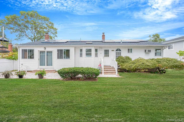 a front view of house with yard and green space