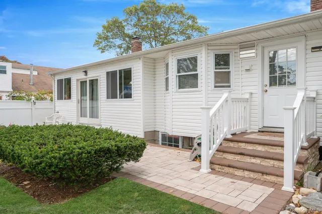 a view of a house with backyard and sitting area