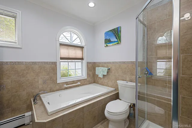 a bathroom with a toilet a sink and a window