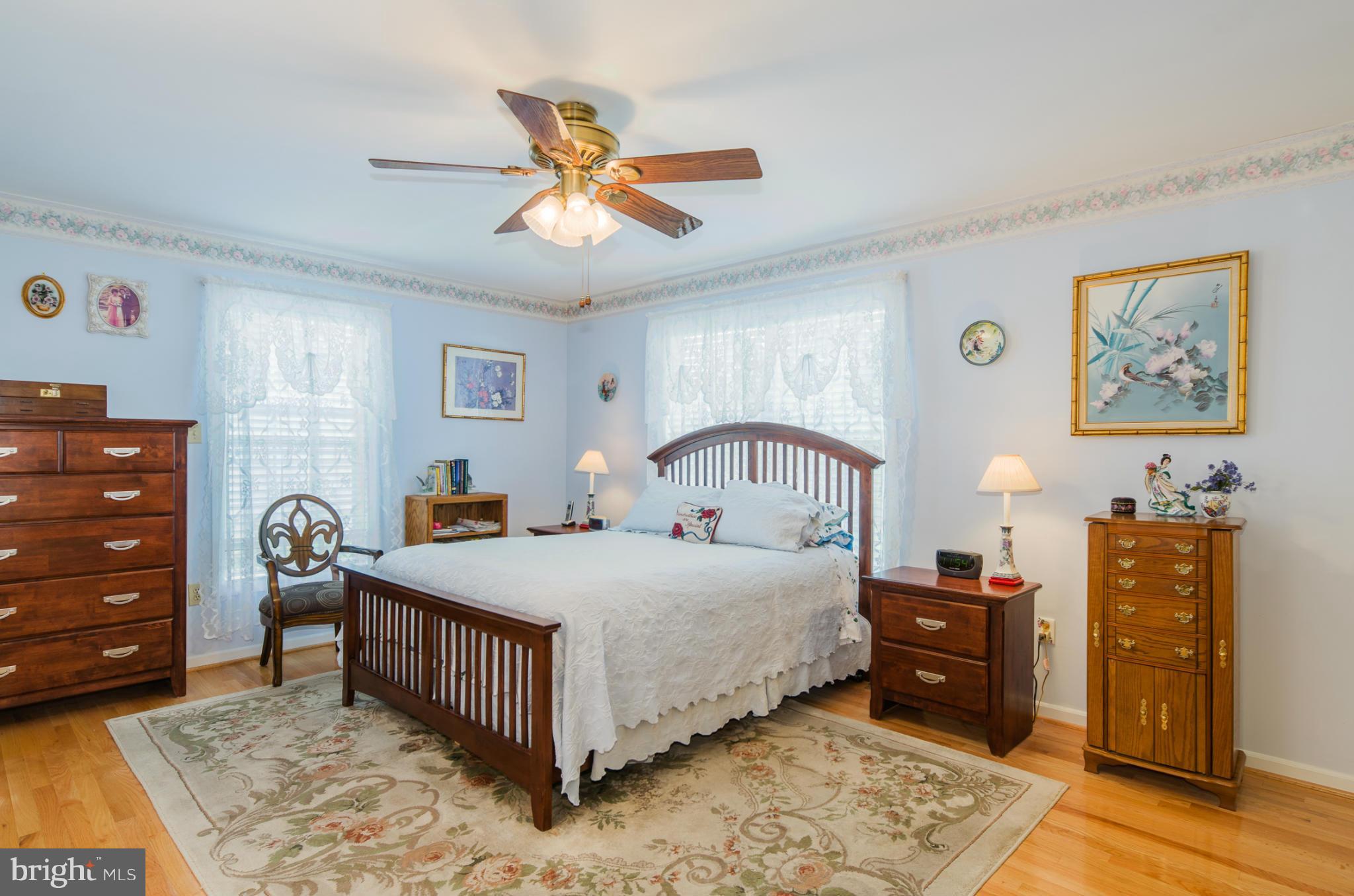 8620 Sandy Plains Road Baltimore, MD 21222 - Photo 10 of 30 a bedroom with a bed and wooden floor