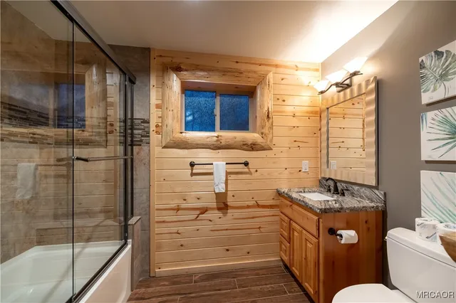 a bathroom with a granite countertop sink mirror vanity and bathtub