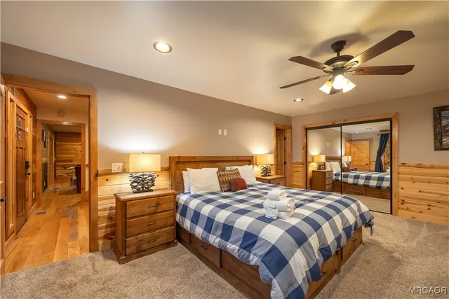 a spacious bedroom with a bed and ceiling fan