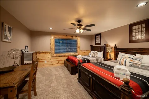 a bedroom with bed and a chandelier