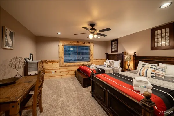 a bedroom with bed and a chandelier