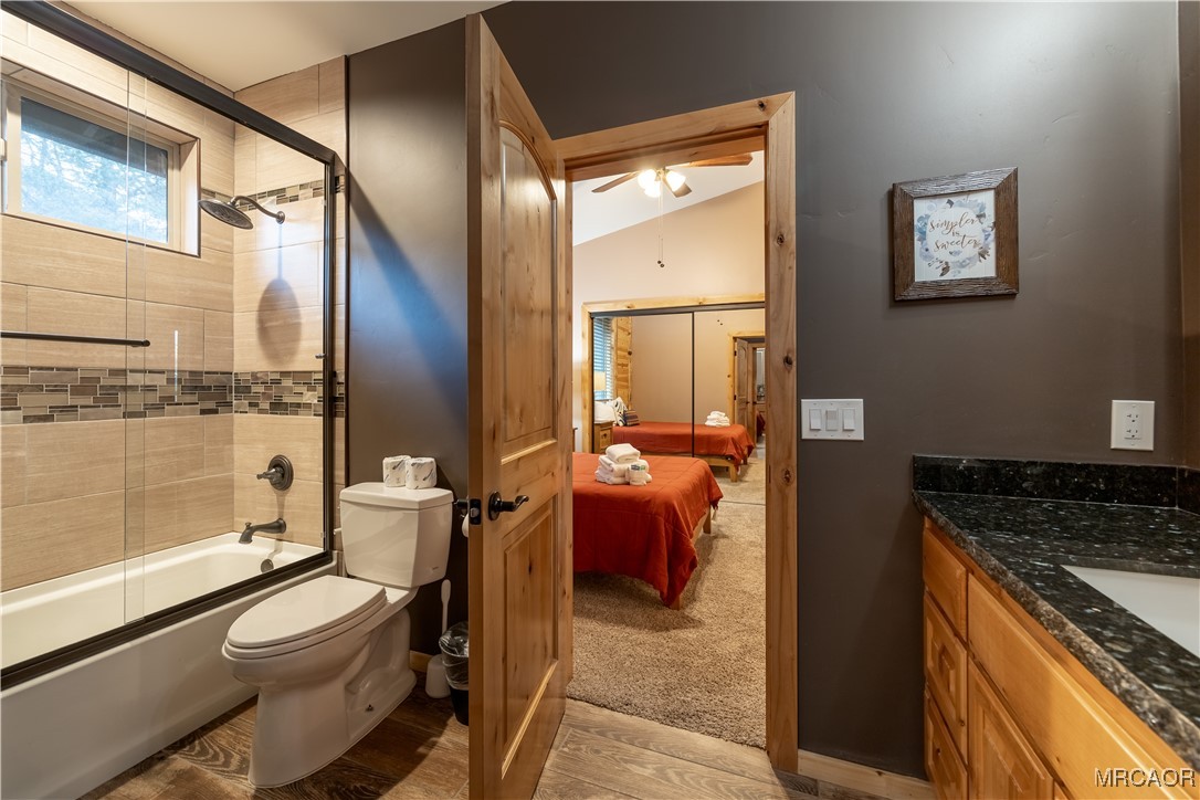 43451 Sheephorn Road Big Bear Lake, CA 92315 - Photo 32 of 44 a bathroom with a granite countertop sink toilet and shower