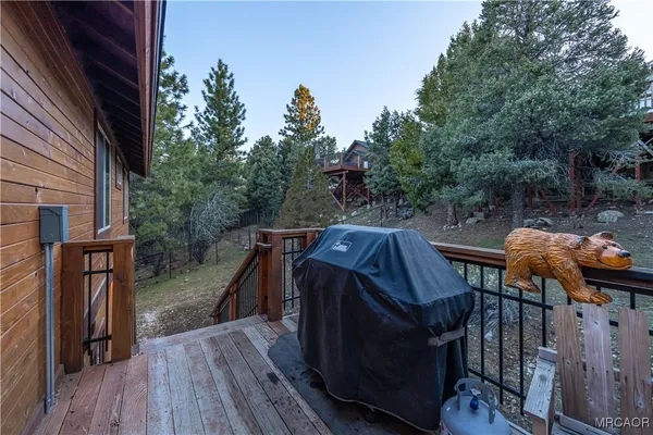 a roof deck with wooden floor and stairs