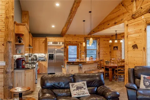 a living room with furniture and large windows