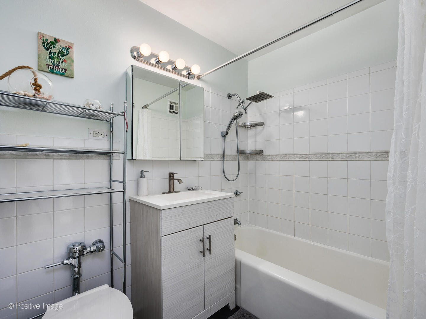 6030 North Sheridan Road, Unit 703 Chicago, IL 60660 - Photo 15 of 15 a bathroom with a sink a toilet and shower