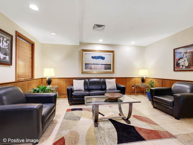 6030 North Sheridan Road, Unit 703 Chicago, IL 60660 - Photo 2 of 15 a living room with furniture and a rug