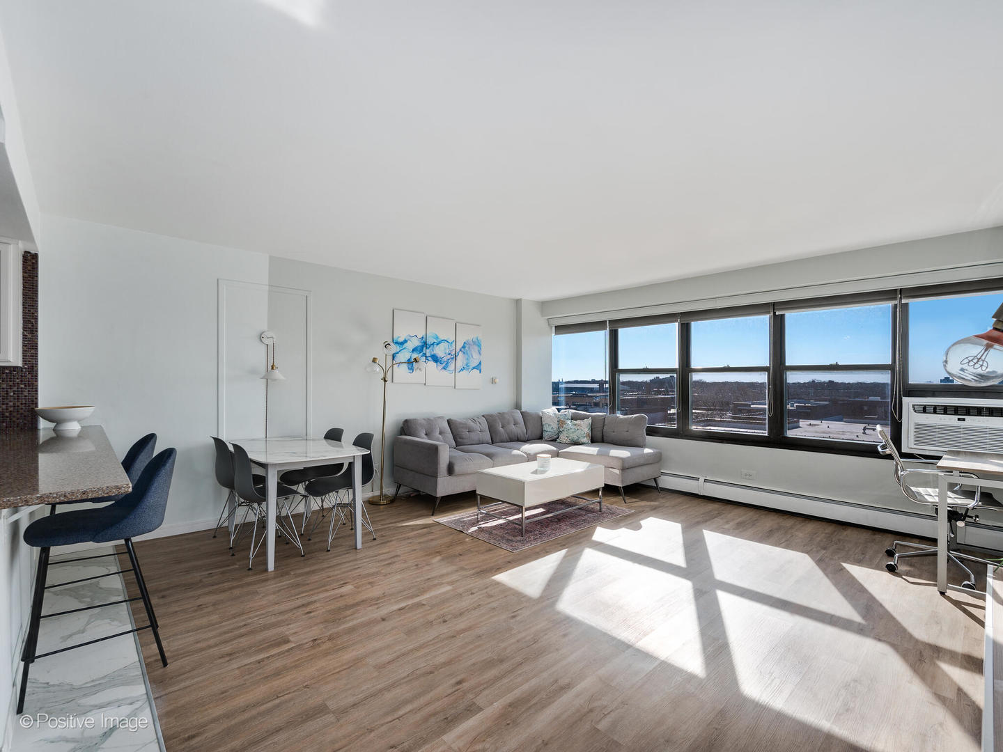 6030 North Sheridan Road, Unit 703 Chicago, IL 60660 - Photo 4 of 15 a living room with furniture and a wooden floor