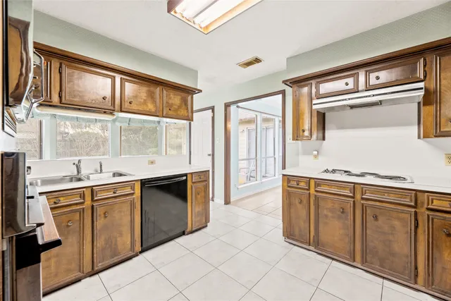 a kitchen with a refrigerator stove and sink