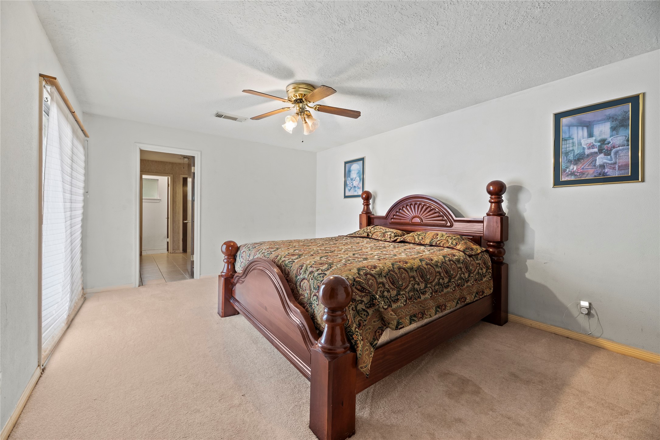 14915 Sun Harbor Drive Houston, TX 77062 - Photo 13 of 28 a bedroom with a bed and a chandelier