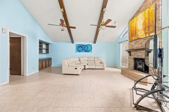 an empty room with mirror and a bathroom