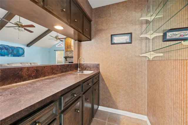 a living room with furniture a clock and a ceiling fan