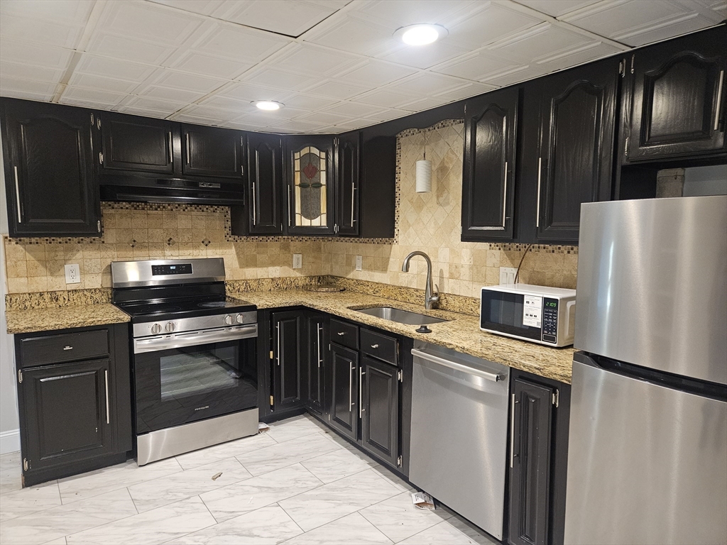 10 Shadowbrook Lane, Unit 19 Milford, MA 01757 - Photo 1 of 11 a kitchen with stainless steel appliances granite countertop a refrigerator stove a sink dishwasher and microwave