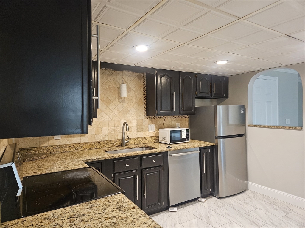 10 Shadowbrook Lane, Unit 19 Milford, MA 01757 - Photo 2 of 11 a kitchen with a sink a stove a refrigerator and cabinets