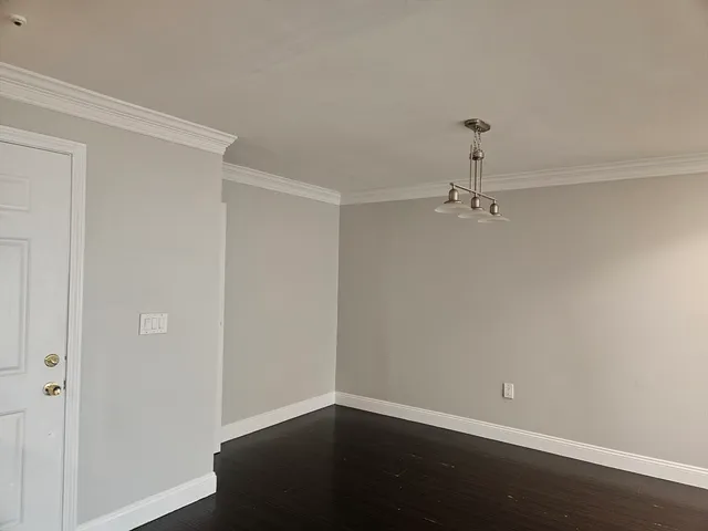 a view of a room with wooden floor