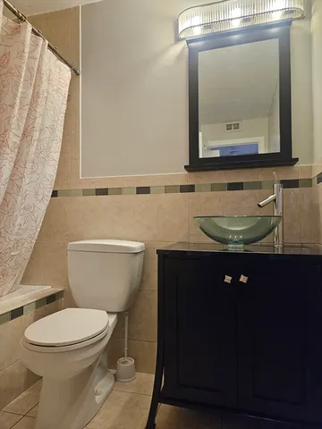 a bathroom with a toilet a sink and a mirror