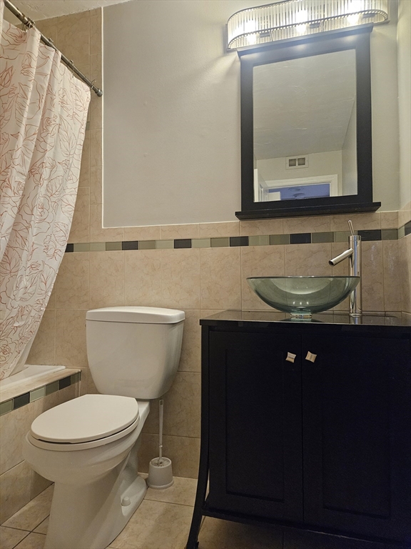 10 Shadowbrook Lane, Unit 19 Milford, MA 01757 - Photo 8 of 11 a bathroom with a toilet a sink and a mirror