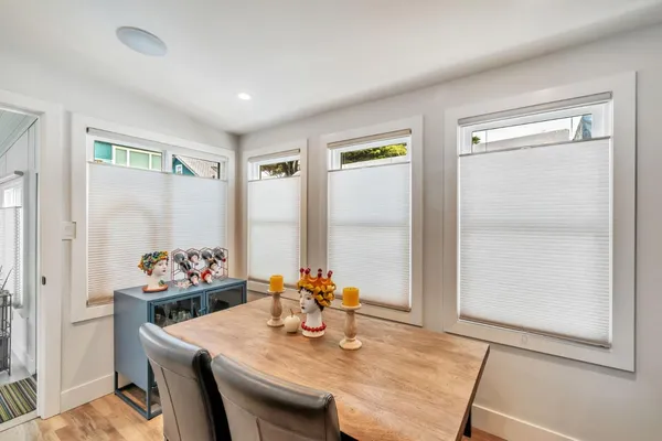 a dining room with furniture and window