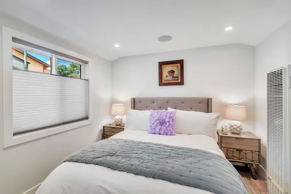 a bedroom with bed and window