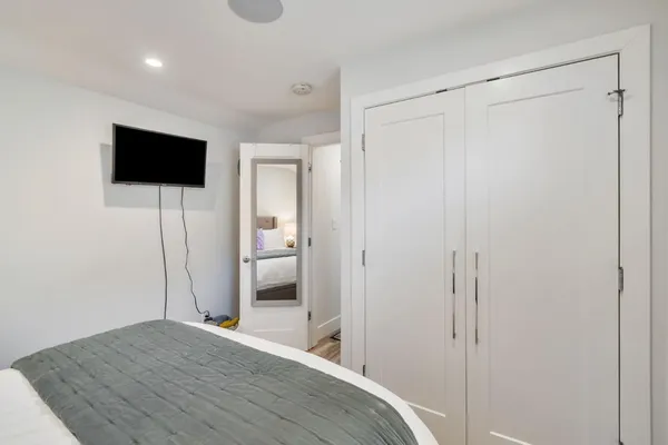 a bedroom with a bed and a flat screen tv