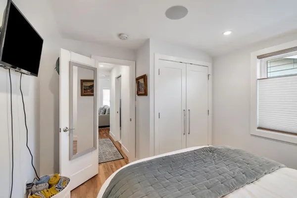 a bedroom with a bed and a flat screen tv