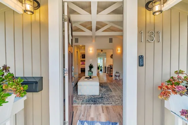 a view of a hallway and a livingroom with furniture