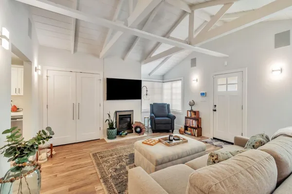 a living room with furniture a flat screen tv and a fireplace