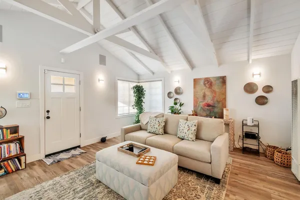 a living room with furniture and wooden floor