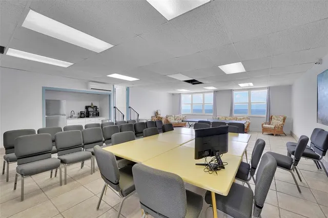 a living room with furniture and large windows