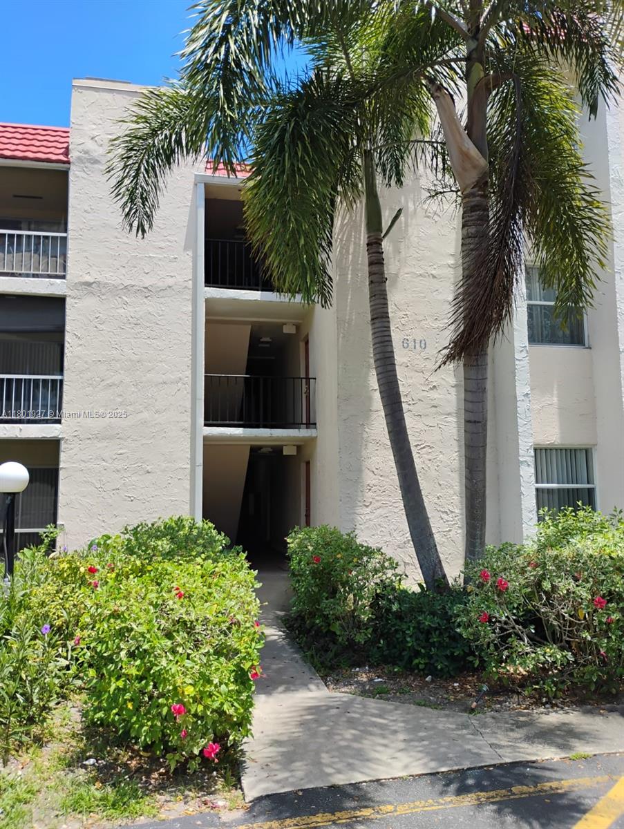 610 Northwest 13th Street, Unit 33 Boca Raton, FL 33486 - Photo 1 of 2 a front view of a house with a garden