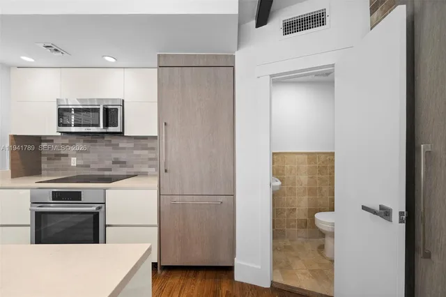 a kitchen with a refrigerator sink and microwave