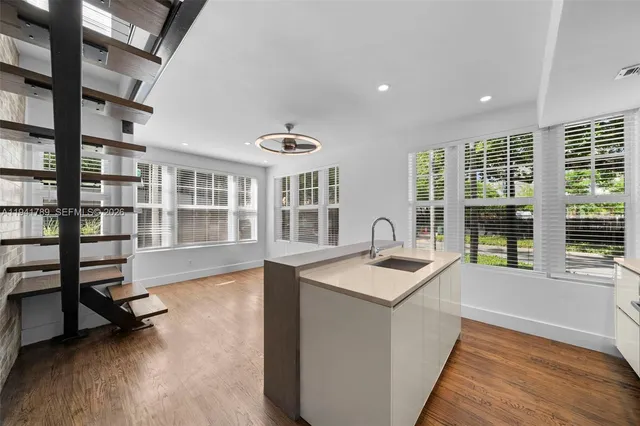 a very nice looking room with a large window and wooden floor