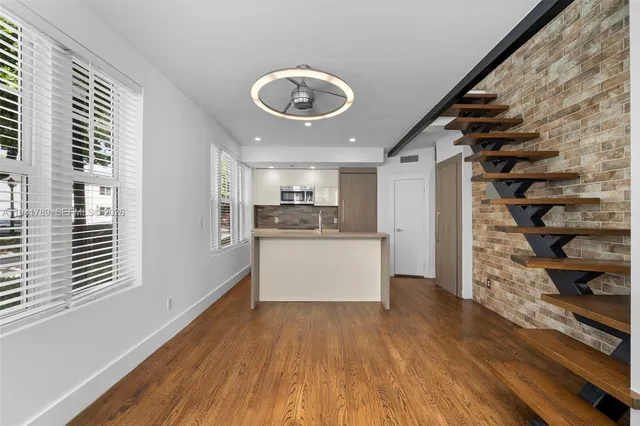 a view of kitchen with cabinets and wooden floor