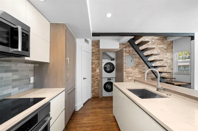 a kitchen with a sink and a stove top oven