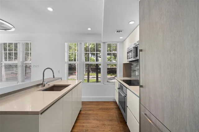 a kitchen with granite countertop a sink and cabinets