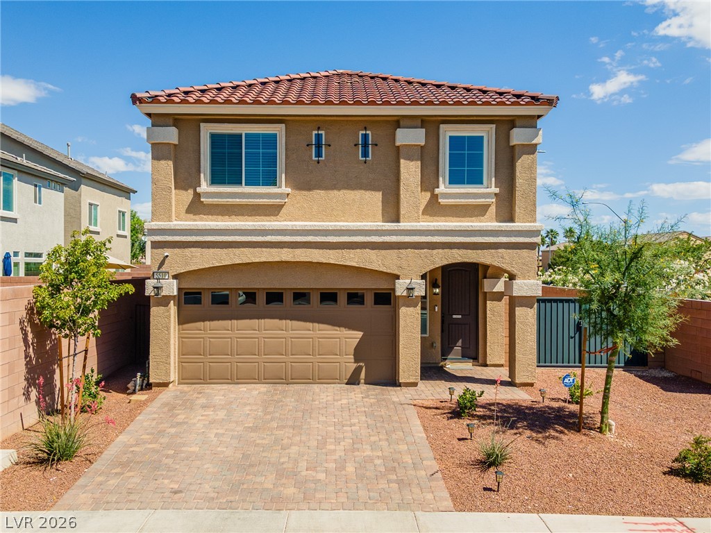 5510 Ripple Ridge Avenue Las Vegas, NV 89139 - Photo 15 of 45 This two-story home features a tiled roof and an attached garage with a paved driveway.