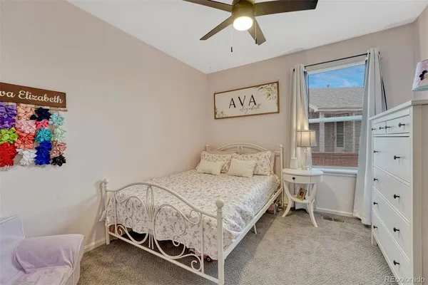 a bedroom with a bed and painting on the wall