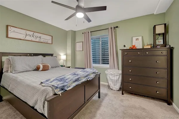a bedroom with a bed and a dresser