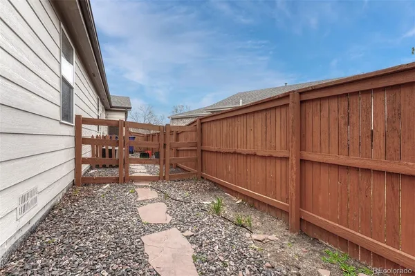 a backyard of a house with wooden fence