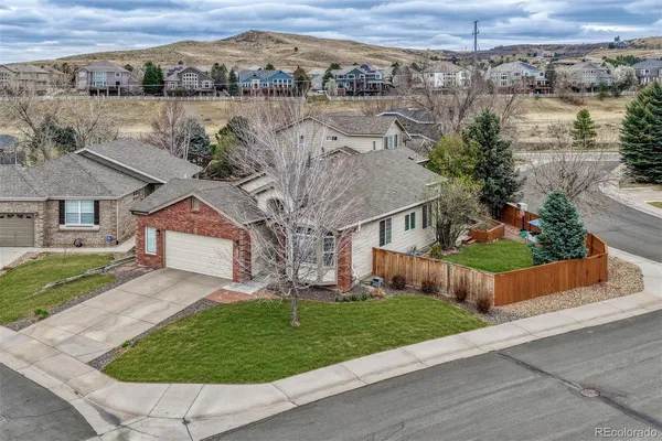 an aerial view of a house with a yard and a garage