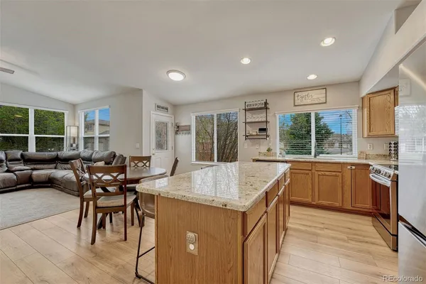 a kitchen with granite countertop sink dining table and chairs