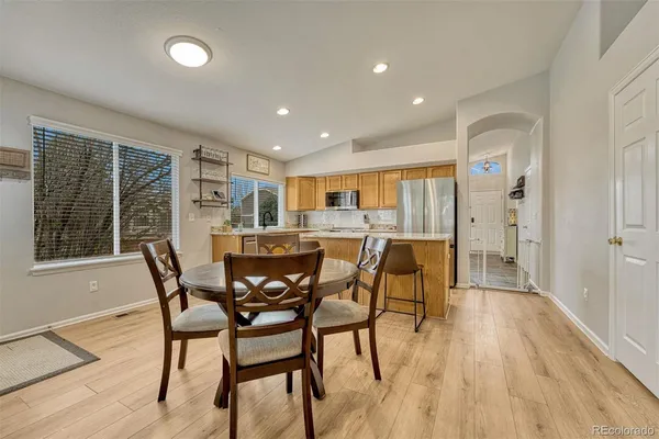a view of a dining room with furniture and wooden floor