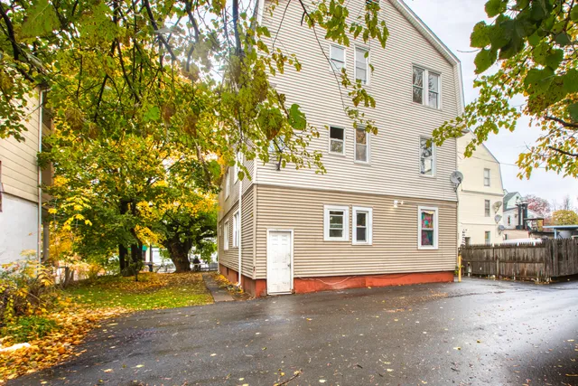 a view of a house with a tree and yard